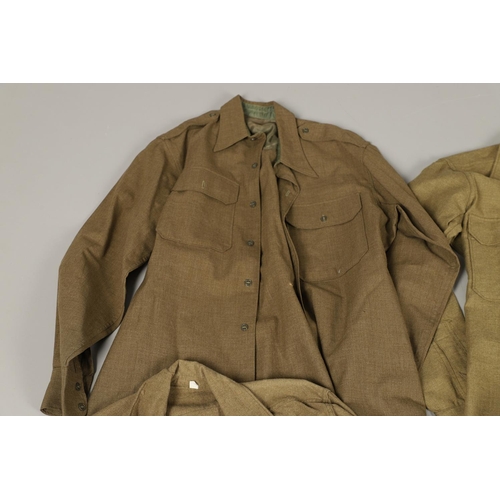 430 - A COLLECTION OF FOURTEEN MILITARY SHIRTS OR LIGHT JACKETS, MANY WITH AMERICAN INSIGNIA. A varied col... 