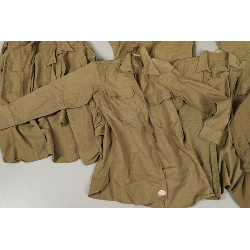 430 - A COLLECTION OF FOURTEEN MILITARY SHIRTS OR LIGHT JACKETS, MANY WITH AMERICAN INSIGNIA. A varied col... 