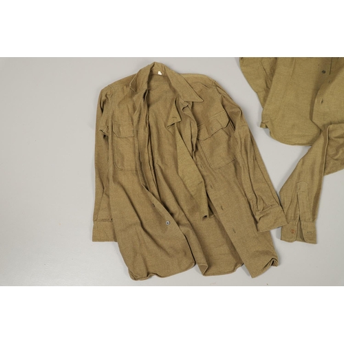 430 - A COLLECTION OF FOURTEEN MILITARY SHIRTS OR LIGHT JACKETS, MANY WITH AMERICAN INSIGNIA. A varied col... 