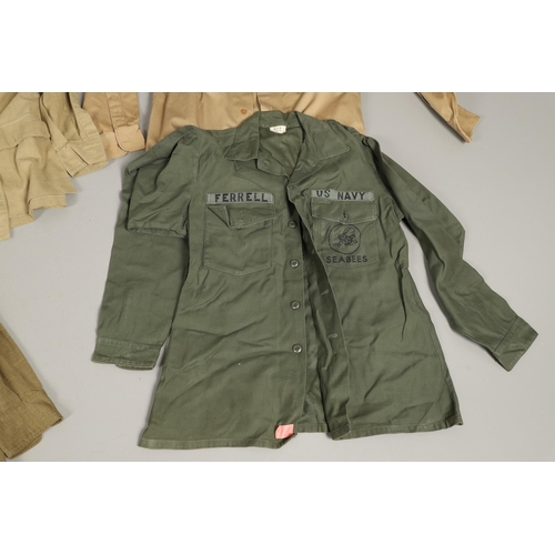 430 - A COLLECTION OF FOURTEEN MILITARY SHIRTS OR LIGHT JACKETS, MANY WITH AMERICAN INSIGNIA. A varied col... 