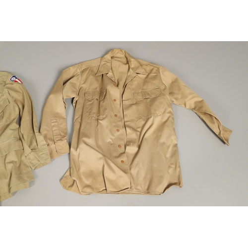 430 - A COLLECTION OF FOURTEEN MILITARY SHIRTS OR LIGHT JACKETS, MANY WITH AMERICAN INSIGNIA. A varied col... 