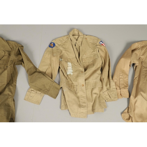 430 - A COLLECTION OF FOURTEEN MILITARY SHIRTS OR LIGHT JACKETS, MANY WITH AMERICAN INSIGNIA. A varied col... 