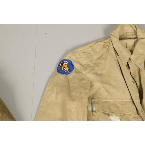 430 - A COLLECTION OF FOURTEEN MILITARY SHIRTS OR LIGHT JACKETS, MANY WITH AMERICAN INSIGNIA. A varied col... 