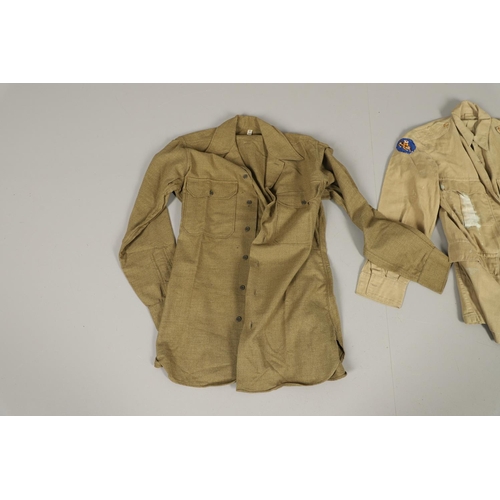 430 - A COLLECTION OF FOURTEEN MILITARY SHIRTS OR LIGHT JACKETS, MANY WITH AMERICAN INSIGNIA. A varied col... 