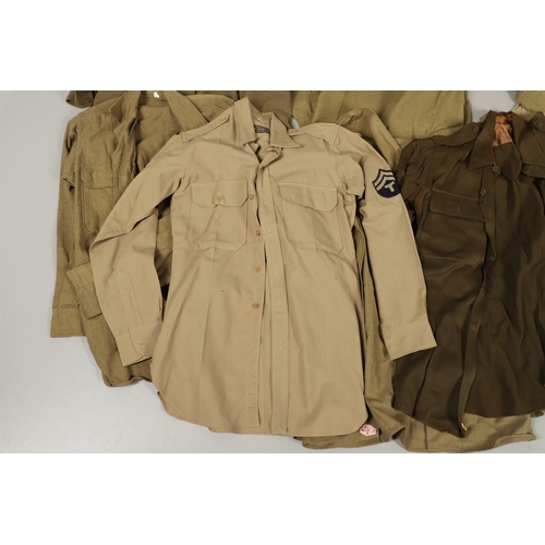 430 - A COLLECTION OF FOURTEEN MILITARY SHIRTS OR LIGHT JACKETS, MANY WITH AMERICAN INSIGNIA. A varied col... 