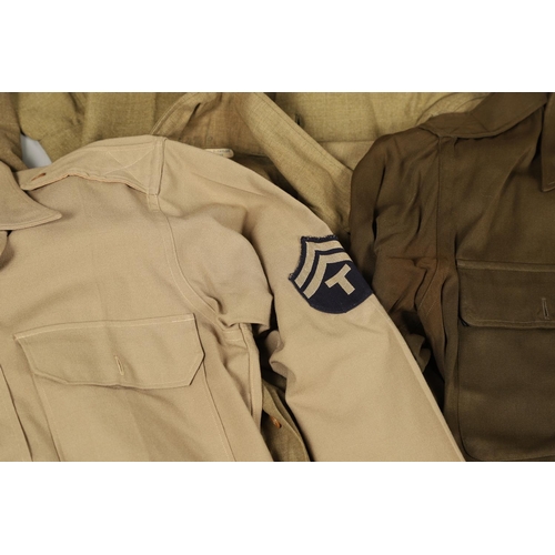 430 - A COLLECTION OF FOURTEEN MILITARY SHIRTS OR LIGHT JACKETS, MANY WITH AMERICAN INSIGNIA. A varied col... 