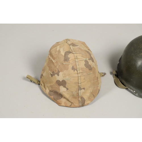 435 - THREE SECOND WORLD WAR OR LATER AMERICAN HELMETS. An American Steel helmet with green painted shell,... 