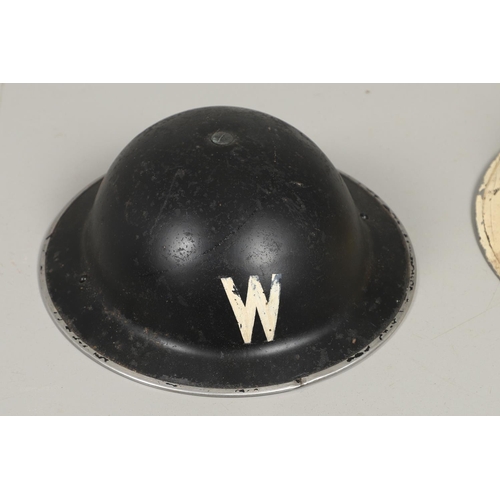 439 - A SECOND WORLD WAR WARDEN's  HELMET AND TWO OTHERS. A Second World War helmet with a white 'W' to th... 