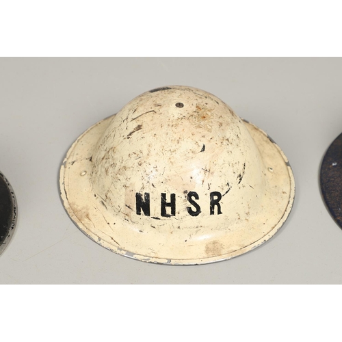 439 - A SECOND WORLD WAR WARDEN's  HELMET AND TWO OTHERS. A Second World War helmet with a white 'W' to th... 