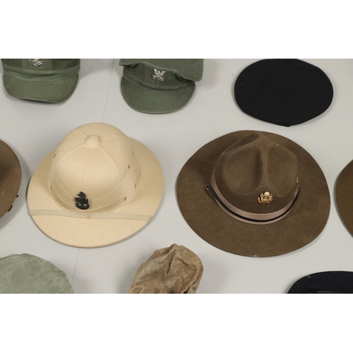 448 - A COLLECTION OF AMERICAN MILITARY HATS TO INCLUDE TWO US NAVY SUN HELMETS. Two US sun helmets, one m... 