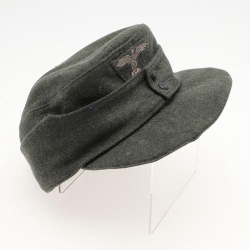 452 - A SECOND WORLD WAR GERMAN WAFFEN-SS M43 TYPE CAP. A fieldgrey cap, the fabric badge with an eagle ov... 