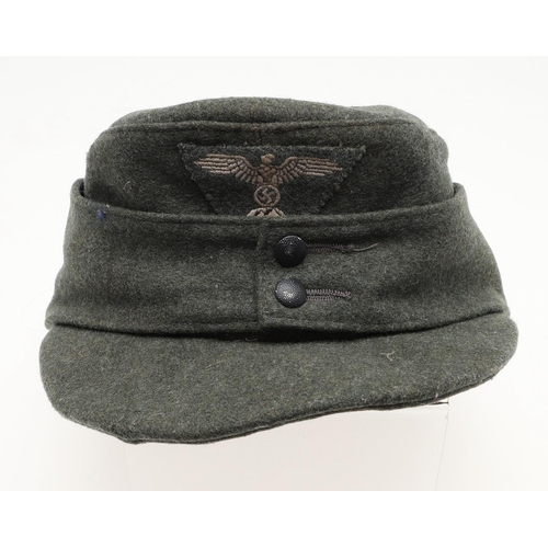 452 - A SECOND WORLD WAR GERMAN WAFFEN-SS M43 TYPE CAP. A fieldgrey cap, the fabric badge with an eagle ov... 