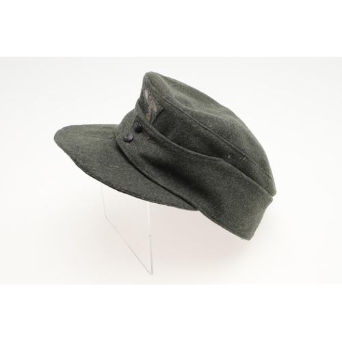 452 - A SECOND WORLD WAR GERMAN WAFFEN-SS M43 TYPE CAP. A fieldgrey cap, the fabric badge with an eagle ov... 