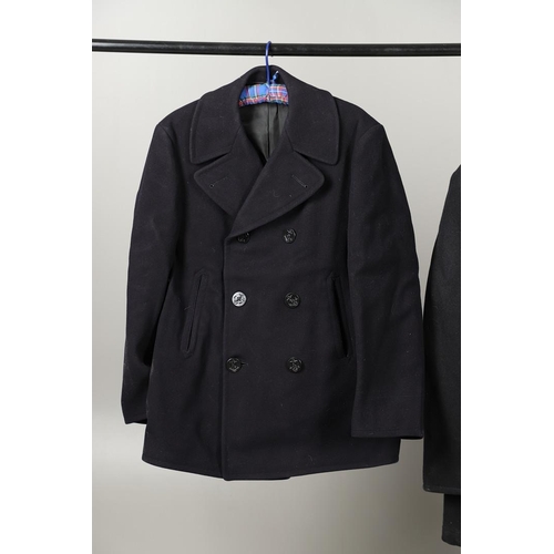 456 - TWO POST SECOND WORLD WAR U.S. NAVY 'PEA' COATS. A dark blue/black navy double breasted 'pea' coat w... 