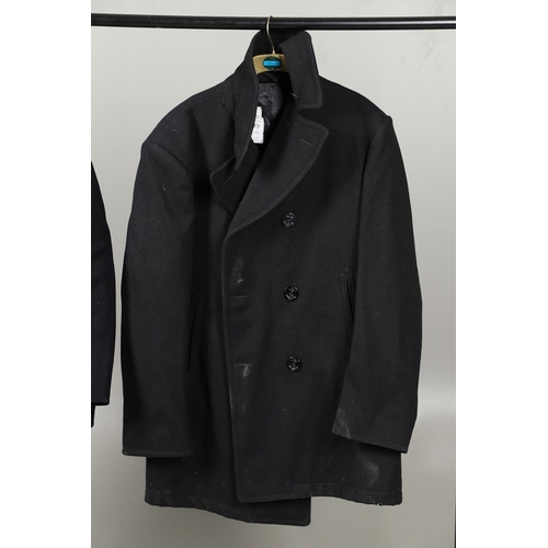 456 - TWO POST SECOND WORLD WAR U.S. NAVY 'PEA' COATS. A dark blue/black navy double breasted 'pea' coat w... 