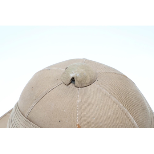 458 - A SECOND WORLD WAR OR LATER GOVERNMENT ISSUE PITH HELMET. A pith helmet stamped with a government is... 