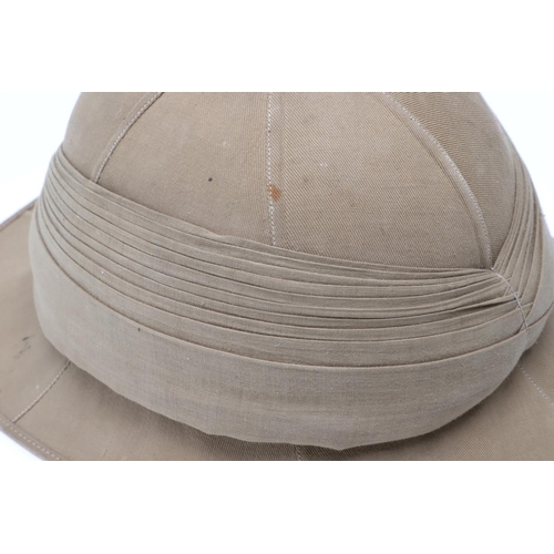 458 - A SECOND WORLD WAR OR LATER GOVERNMENT ISSUE PITH HELMET. A pith helmet stamped with a government is... 