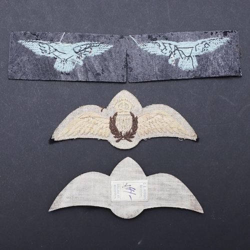 474 - TWO RAF CAP BADGES, PADDED AND FLAT AND TWO UN-ISSUED SHOULDER PATCHES. Two R.A.F. cap badges, one o... 