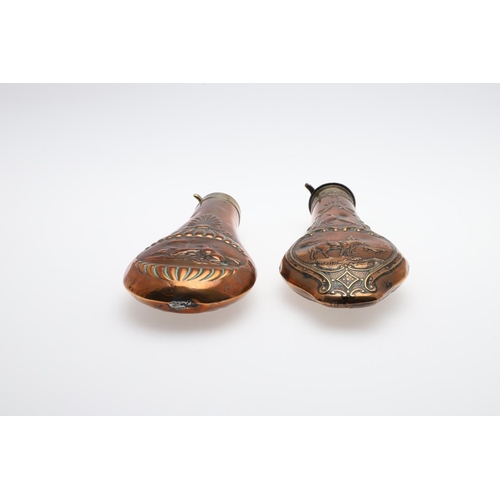 486 - TWO LATE 19TH CENTURY COPPER AND BRASS POWDER FLASKS. A Copper bodied powder flask decorated with a ... 