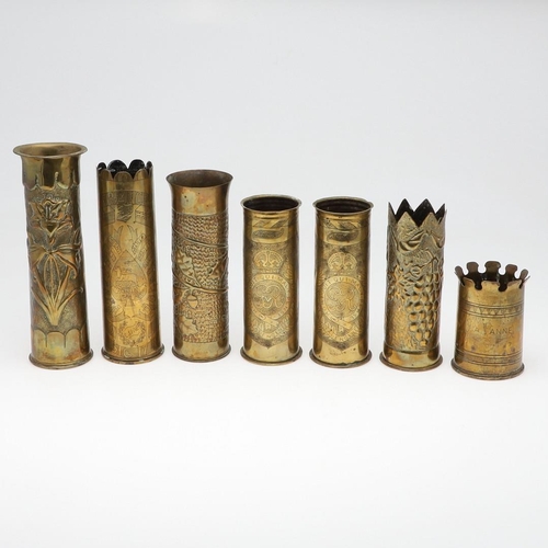 511 - AN INTERESTING COLLECTION OF SEVEN FIRST WORLD WAR TRENCH ART SHELL CASES. A pair of Trench art vase... 