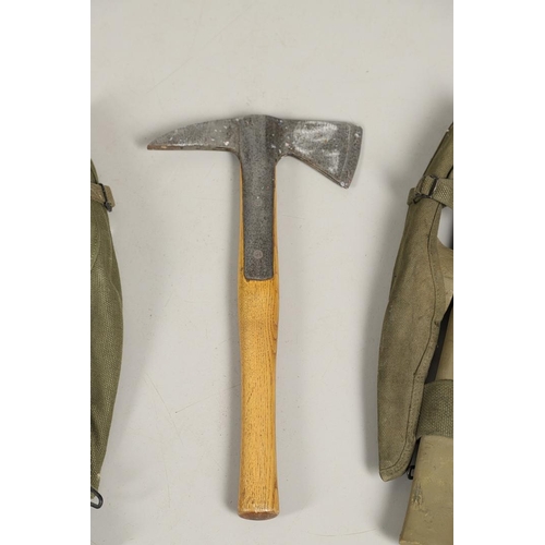 514 - THREE AMERICAN SECOND WORLD WAR MILITARY PICKAXES AND TWO AXES. A U.S. Military webbing mounted pick... 