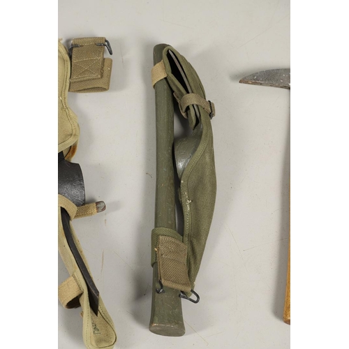 514 - THREE AMERICAN SECOND WORLD WAR MILITARY PICKAXES AND TWO AXES. A U.S. Military webbing mounted pick... 