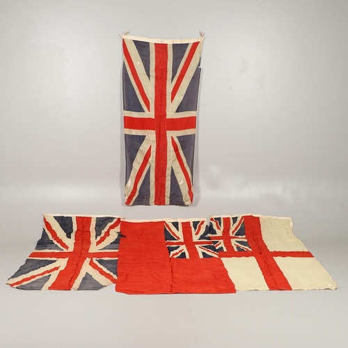 543 - A COLLECTION OF BRITISH FLAGS: TWO UNION JACKS, A RED AND WHITE ENSIGN. A Union Jack of sewn constru... 