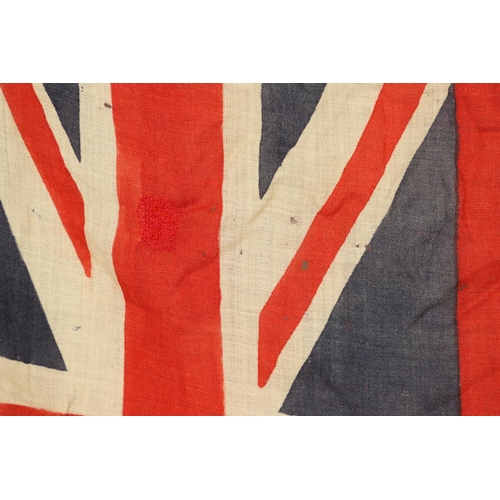 543 - A COLLECTION OF BRITISH FLAGS: TWO UNION JACKS, A RED AND WHITE ENSIGN. A Union Jack of sewn constru... 