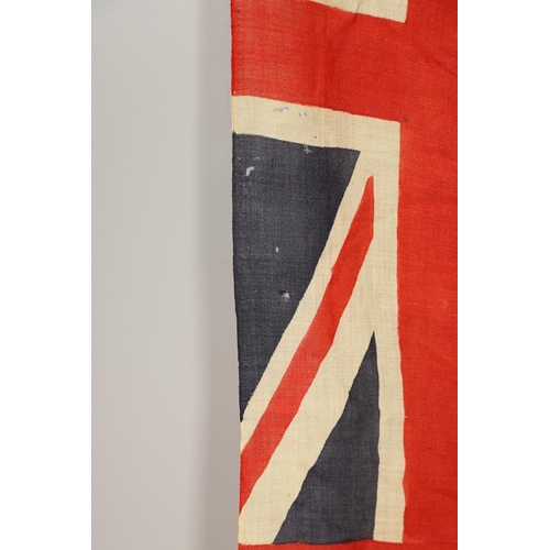 543 - A COLLECTION OF BRITISH FLAGS: TWO UNION JACKS, A RED AND WHITE ENSIGN. A Union Jack of sewn constru... 