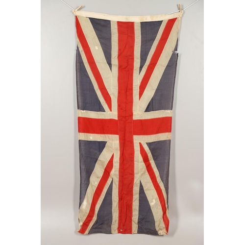 543 - A COLLECTION OF BRITISH FLAGS: TWO UNION JACKS, A RED AND WHITE ENSIGN. A Union Jack of sewn constru... 