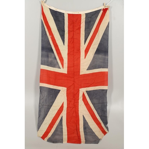 543 - A COLLECTION OF BRITISH FLAGS: TWO UNION JACKS, A RED AND WHITE ENSIGN. A Union Jack of sewn constru... 