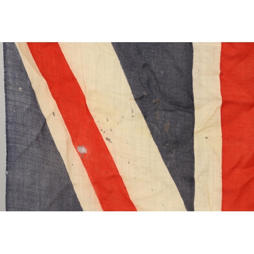 543 - A COLLECTION OF BRITISH FLAGS: TWO UNION JACKS, A RED AND WHITE ENSIGN. A Union Jack of sewn constru... 