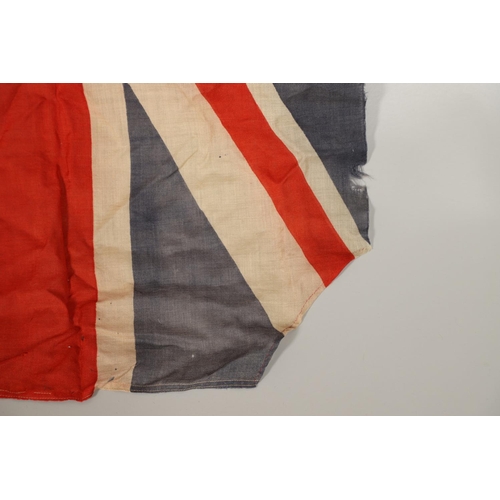 543 - A COLLECTION OF BRITISH FLAGS: TWO UNION JACKS, A RED AND WHITE ENSIGN. A Union Jack of sewn constru... 