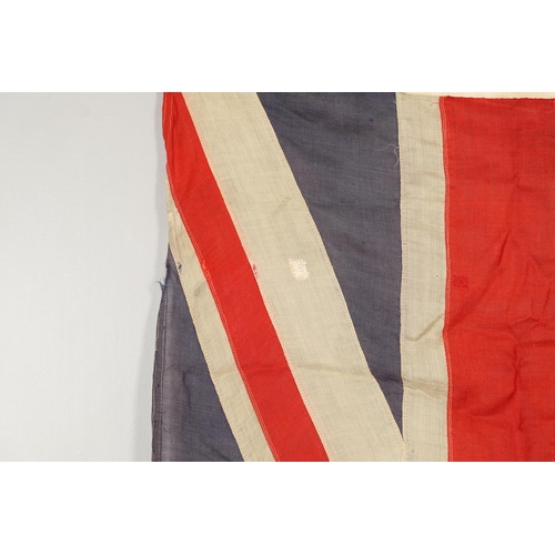 543 - A COLLECTION OF BRITISH FLAGS: TWO UNION JACKS, A RED AND WHITE ENSIGN. A Union Jack of sewn constru... 