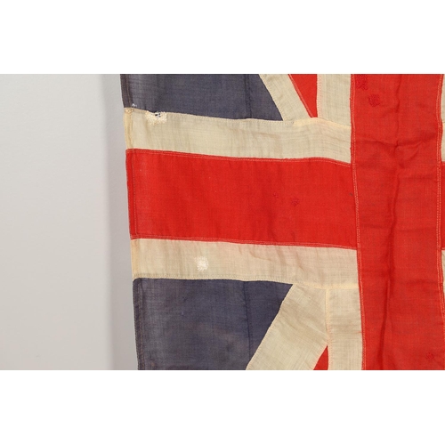 543 - A COLLECTION OF BRITISH FLAGS: TWO UNION JACKS, A RED AND WHITE ENSIGN. A Union Jack of sewn constru... 