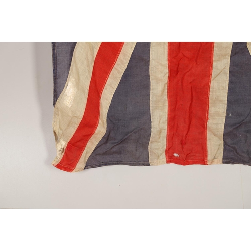 543 - A COLLECTION OF BRITISH FLAGS: TWO UNION JACKS, A RED AND WHITE ENSIGN. A Union Jack of sewn constru... 