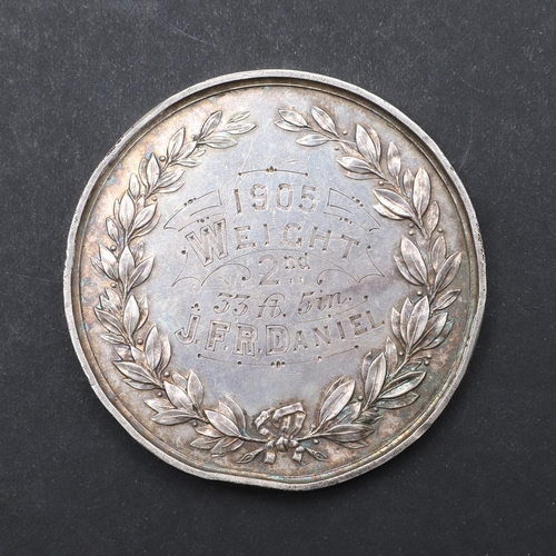 574 - A WINCHESTER COLLEGE QUINCENTENARY MEDAL BY GEORGE FRAMPTON, AND ANOTHER. A large silvered presentat... 