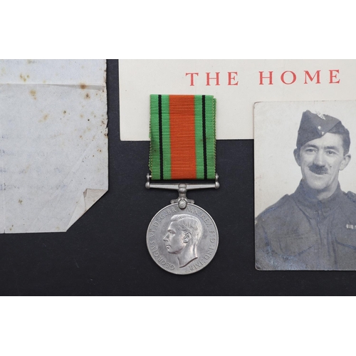 625 - A SECOND WORLD WAR DEFENCE MEDAL AND LAPEL BADGE TO THE HOME GUARD. A Second World War Defence Medal... 