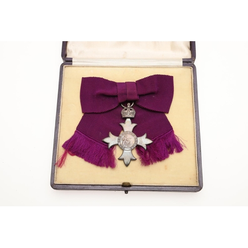 629 - A GEORGE V M.B.E. LADIES AWARD. An MBE on first type civilian ribbon, hallmarked for London 1918, Ga... 