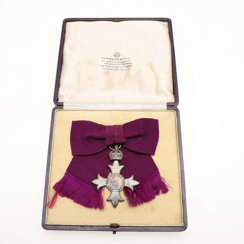 629 - A GEORGE V M.B.E. LADIES AWARD. An MBE on first type civilian ribbon, hallmarked for London 1918, Ga... 