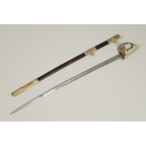 90 - A FIRST WORLD WAR NAVAL OFFICERS SWORD AND SCABBARD. With a 79cm pointed and sharpened blade decorat... 