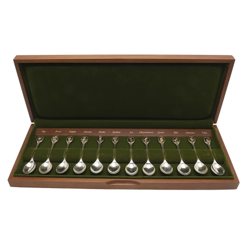 1 - AN ELIZABETH II CASED SET OF TWELVE PARCELGILT ROYAL HORTICULTURAL SILVER TEASPOONS. each gilded ter... 