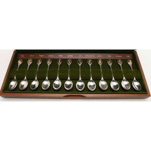 1 - AN ELIZABETH II CASED SET OF TWELVE PARCELGILT ROYAL HORTICULTURAL SILVER TEASPOONS. each gilded ter... 