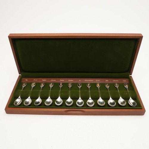 1 - AN ELIZABETH II CASED SET OF TWELVE PARCELGILT ROYAL HORTICULTURAL SILVER TEASPOONS. each gilded ter... 