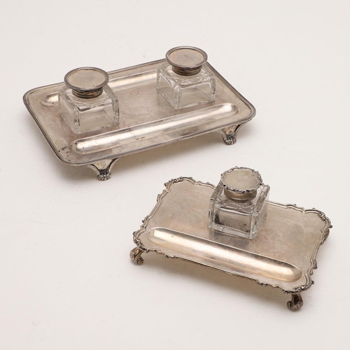 100 - TWO EARLY 20TH CENTURY SILVER INKSTANDS. one rectangular, with rounded corners, a reeded border and ... 