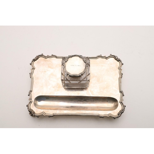 100 - TWO EARLY 20TH CENTURY SILVER INKSTANDS. one rectangular, with rounded corners, a reeded border and ... 