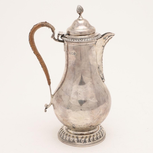 101 - A LATE VICTORIAN SILVER HOT WATER JUG. baluster form, with gadrooned borders, a cane-insulated handl... 