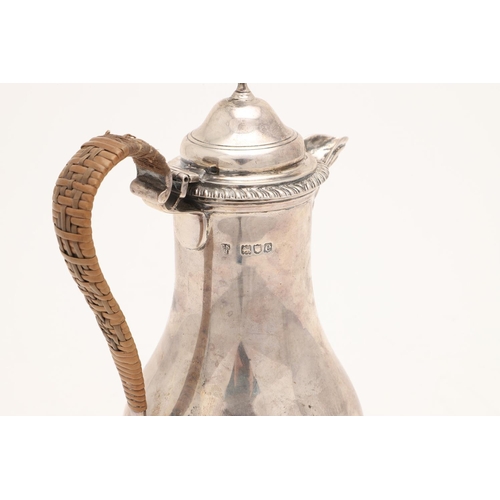 101 - A LATE VICTORIAN SILVER HOT WATER JUG. baluster form, with gadrooned borders, a cane-insulated handl... 