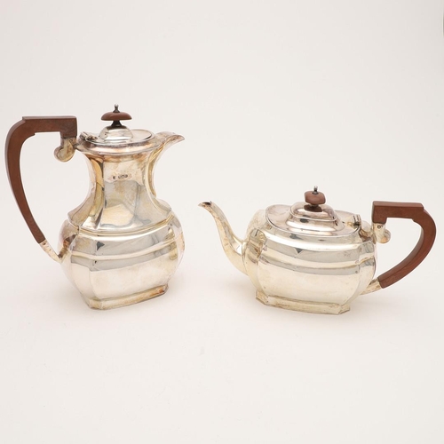 102 - AN ELIZABETH II SILVER TEA POT & MATCHING HOT WATER JUG. of shaped oblong form, with angular handles... 