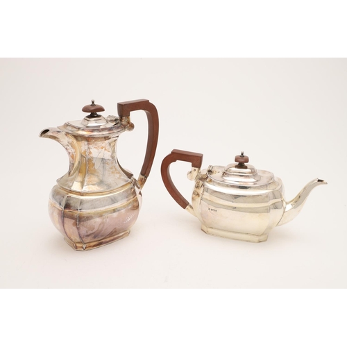 102 - AN ELIZABETH II SILVER TEA POT & MATCHING HOT WATER JUG. of shaped oblong form, with angular handles... 